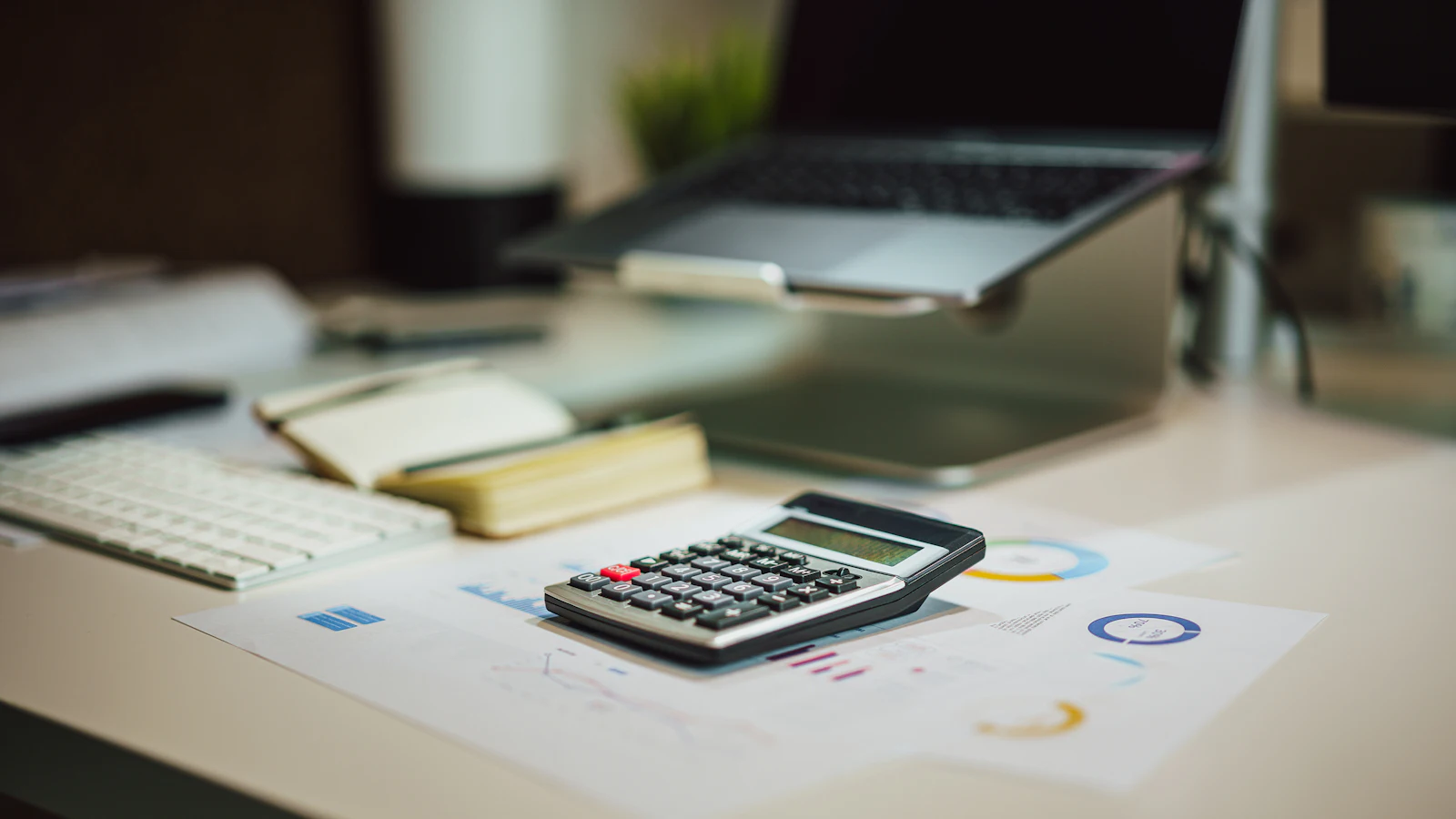 A calculator and accounting documents on a desk