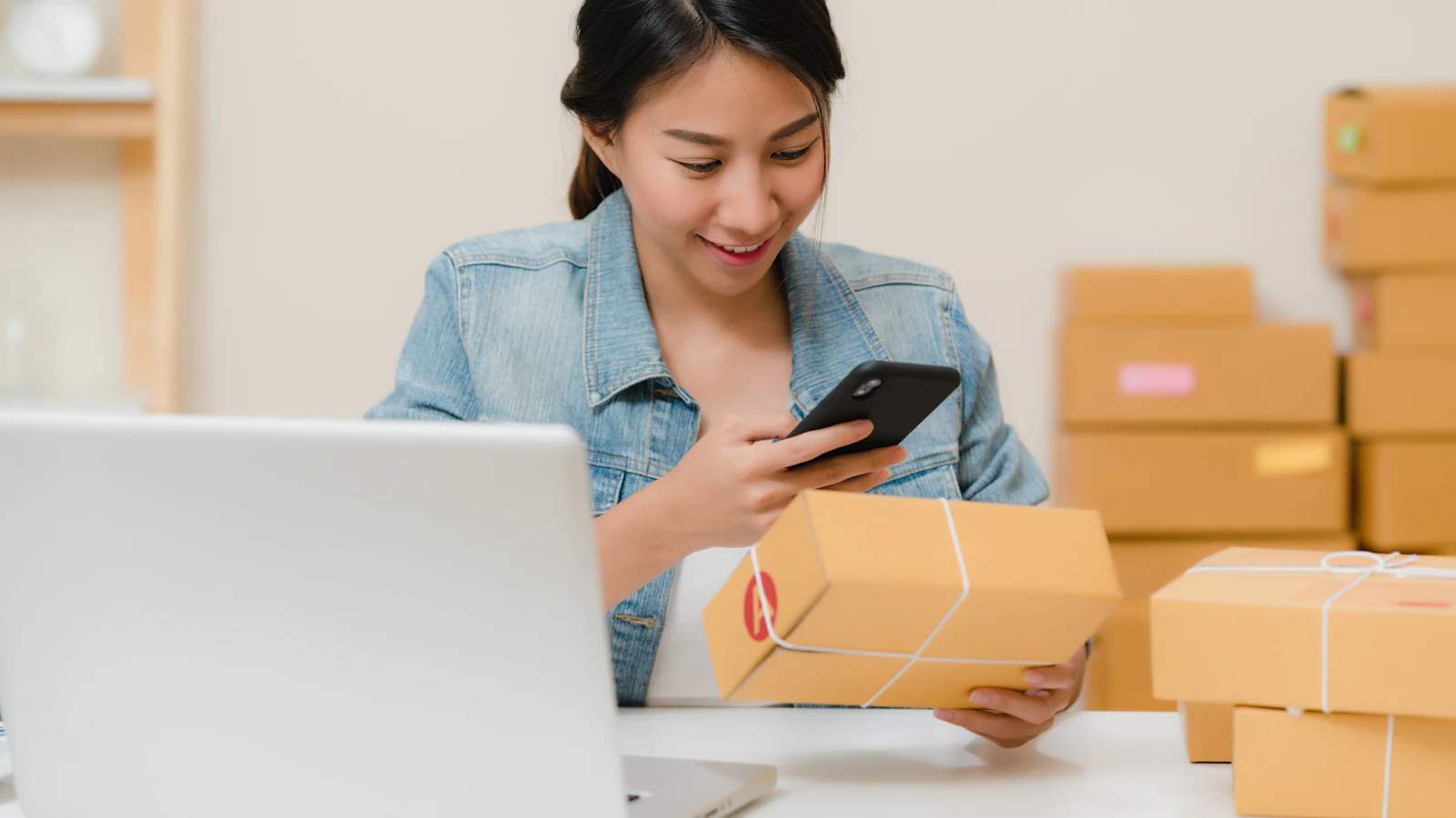 Packed ecommerce orders next to a laptop, representing setting up an online shop