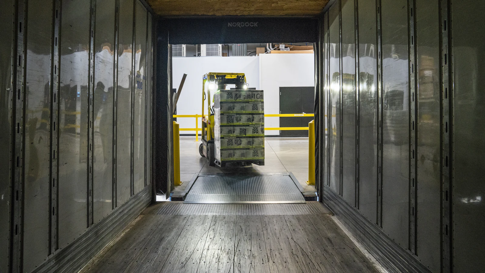 Forklift moving pallets in a warehouse, representing warehouse management and logistics